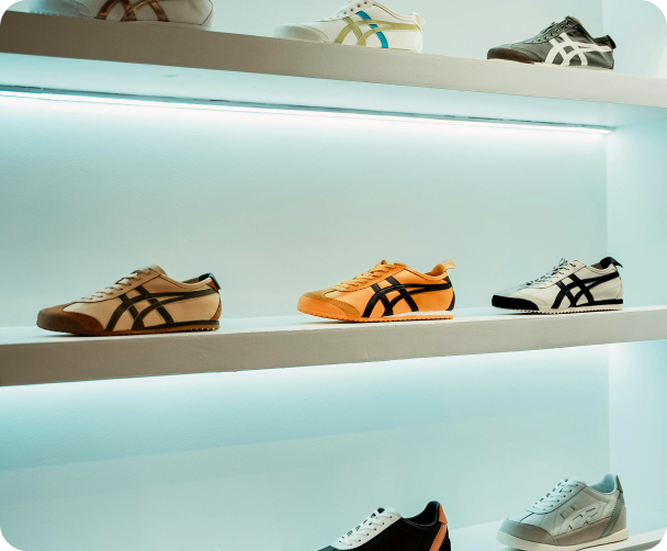 vesko's landing page, hero section with organized display of various shoes in sleek, modern shoe cabinets with soft lighting, showcasing casual, formal, and athletic footwear.